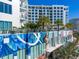 Exterior shot of condo building featuring a mural, landscaping, and high-rise architecture at 111 S Pineapple Ave # 613, Sarasota, FL 34236