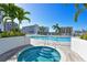 Luxurious outdoor pool and hot tub area with palm trees and city views for upscale living at 111 S Pineapple Ave # 613, Sarasota, FL 34236