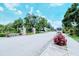 Community entrance to Fairway Glen, featuring manicured landscaping and signage at 111 Woodbridge Dr # 202, Venice, FL 34293