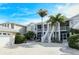 Beautifully landscaped two-story condo with pristine sidewalks and manicured bushes at 111 Woodbridge Dr # 202, Venice, FL 34293