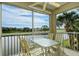 Outdoor patio boasts peaceful lake views, table, and chairs at 111 Woodbridge Dr # 202, Venice, FL 34293