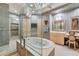 Upscale bathroom with soaking tub, glass shower, and dual vanities at 50 Central Ave # 17Phc, Sarasota, FL 34236