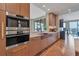 Modern kitchen with custom cabinetry and herringbone floors at 50 Central Ave # 17Phc, Sarasota, FL 34236