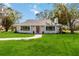 Newly renovated home with modern exterior and lush lawn at 5246 Bay Shore Rd, Sarasota, FL 34234