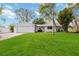 White modern home with attached garage and spacious lawn at 5246 Bay Shore Rd, Sarasota, FL 34234