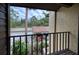 Private balcony with views of the parking lot and lush landscaping at 947 Sunridge Way # A-3, Sarasota, FL 34234