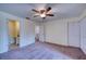 Comfortable bedroom with ceiling fan and access to bathroom at 947 Sunridge Way # A-3, Sarasota, FL 34234