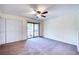 Well-lit bedroom with ceiling fan and access to balcony at 947 Sunridge Way # A-3, Sarasota, FL 34234