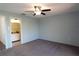 Bright bedroom with ceiling fan and ensuite bathroom access at 947 Sunridge Way # A-3, Sarasota, FL 34234