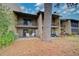 Back exterior view showing patio, large tree, and building at 947 Sunridge Way # A-3, Sarasota, FL 34234