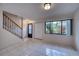 Living room with tile floor, entryway, and staircase at 947 Sunridge Way # A-3, Sarasota, FL 34234