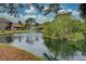 Community pond with fountain and lush landscaping at 947 Sunridge Way # A-3, Sarasota, FL 34234