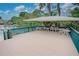 Elevated pool deck with shaded seating area at 947 Sunridge Way # A-3, Sarasota, FL 34234