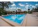 Community pool with lounge chairs and a covered area at 947 Sunridge Way # A-3, Sarasota, FL 34234