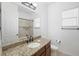 Well-lit bathroom featuring a granite countertop vanity and shower and bathtub combo at 12928 24Th E Ct, Parrish, FL 34219