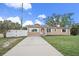 Tan house with white shutters, driveway, and landscaped lawn at 15 Tulane Rd, Venice, FL 34293