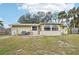 Large backyard with screened enclosure, spacious grassy area, and wooden fence at 2947 Arrowhead Rd, Venice, FL 34293