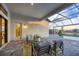 Covered patio with comfortable seating overlooking pool at 8983 Baroque Ter, Sarasota, FL 34240