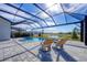 Relaxing poolside lounge chairs under a screened lanai at 8983 Baroque Ter, Sarasota, FL 34240