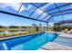 Inviting pool with screened patio and lake view at 8983 Baroque Ter, Sarasota, FL 34240