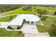 Main house with metal roof, paver driveway and patio, surrounded by lush landscaping at 3630 Verna Rd, Myakka City, FL 34251