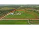 Aerial view showing main house, guesthouse, and horse stables on large lot at 3630 Verna Rd, Myakka City, FL 34251