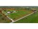 Aerial view of expansive property with main house, guesthouse, and horse stable at 3630 Verna Rd, Myakka City, FL 34251