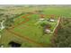 Aerial view of property with main house, guesthouse, stable, and expansive land at 3630 Verna Rd, Myakka City, FL 34251