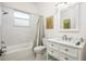 Updated bathroom featuring a bathtub, vanity with marble countertop and gray marble tile at 3630 Verna Rd, Myakka City, FL 34251