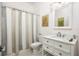 Clean bathroom with shower/tub combo, white vanity, and gray tile floors at 3630 Verna Rd, Myakka City, FL 34251