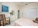 Bright bedroom with a queen bed, dresser, and a charming rocking chair at 3630 Verna Rd, Myakka City, FL 34251