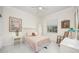 Cozy bedroom with a queen-size bed, wooden rocking chair, and two nightstands at 3630 Verna Rd, Myakka City, FL 34251