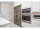 Kitchen with stainless steel appliances and white cabinetry at 3630 Verna Rd, Myakka City, FL 34251
