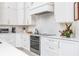 Modern kitchen with white cabinets, stainless steel appliances, and quartz countertops at 3630 Verna Rd, Myakka City, FL 34251