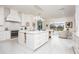 Spacious kitchen with white cabinets, large island, and stainless steel appliances at 3630 Verna Rd, Myakka City, FL 34251