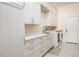 Bright laundry room with washer, dryer and custom cabinetry at 3630 Verna Rd, Myakka City, FL 34251