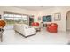 Living room with coral armchairs and view of pool area at 3630 Verna Rd, Myakka City, FL 34251