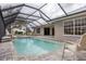 Spacious pool and patio with covered lanai and serene view at 3630 Verna Rd, Myakka City, FL 34251