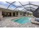 Relaxing pool and spa with covered patio, outdoor seating, and scenic view at 3630 Verna Rd, Myakka City, FL 34251
