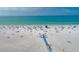 Drone view of crowded beach with walkway at 1215 S Portofino Dr # 404, Sarasota, FL 34242