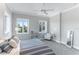 Guest bedroom with striped bedding and two windows at 1243 Starboard Ln, Sarasota, FL 34242