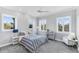 Guest bedroom with striped bedding and ample natural light at 1243 Starboard Ln, Sarasota, FL 34242