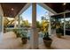 Covered patio with columns, plants, and pool view at 1243 Starboard Ln, Sarasota, FL 34242