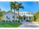 White two-story home with palm trees and brick driveway at 1243 Starboard Ln, Sarasota, FL 34242