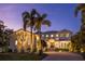 Stunning two-story home with palm trees and a paved driveway at 1243 Starboard Ln, Sarasota, FL 34242