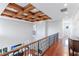 Elegant upper hallway with hardwood floors and coffered ceiling at 1243 Starboard Ln, Sarasota, FL 34242