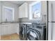 Laundry room with modern washer and dryer and granite countertops at 1243 Starboard Ln, Sarasota, FL 34242