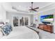 Main bedroom features a large TV and private balcony access at 1243 Starboard Ln, Sarasota, FL 34242