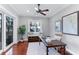 Home office with wood desk, window seat and hardwood floors at 1243 Starboard Ln, Sarasota, FL 34242