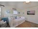 Bright guest bedroom with daybed, TV, and coastal decor at 1318 6Th W St, Palmetto, FL 34221